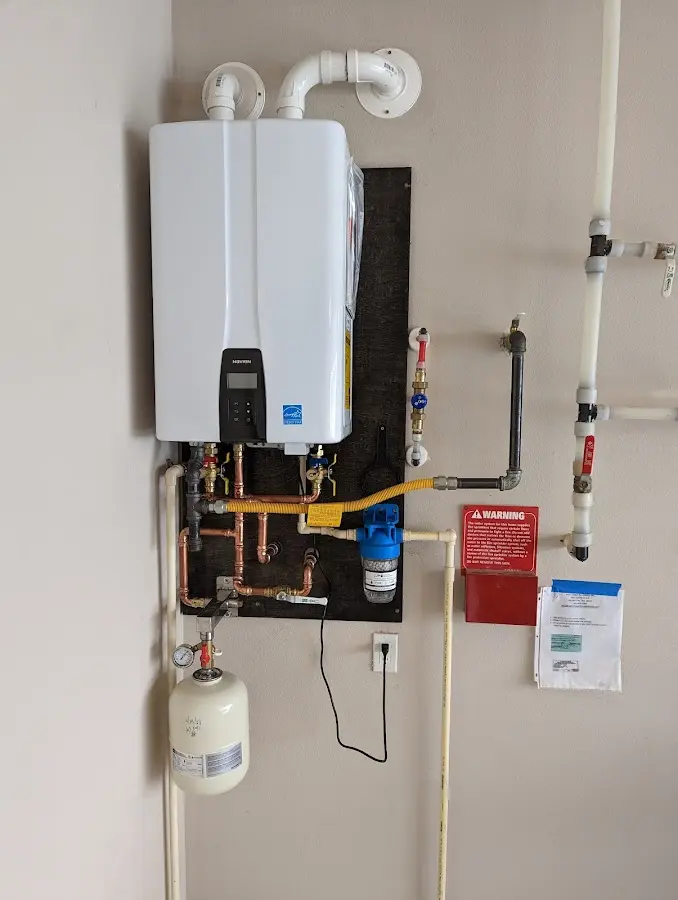 Professional plumber installing copper piping in a Hillsdale home